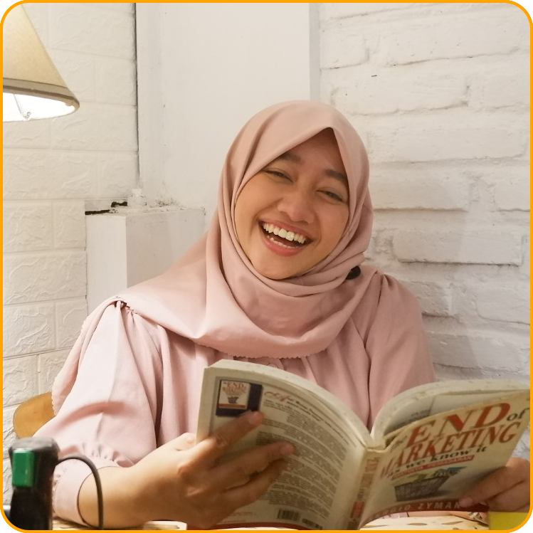 Dwi, a student from Indonesia, smiles while reading a book in her flat